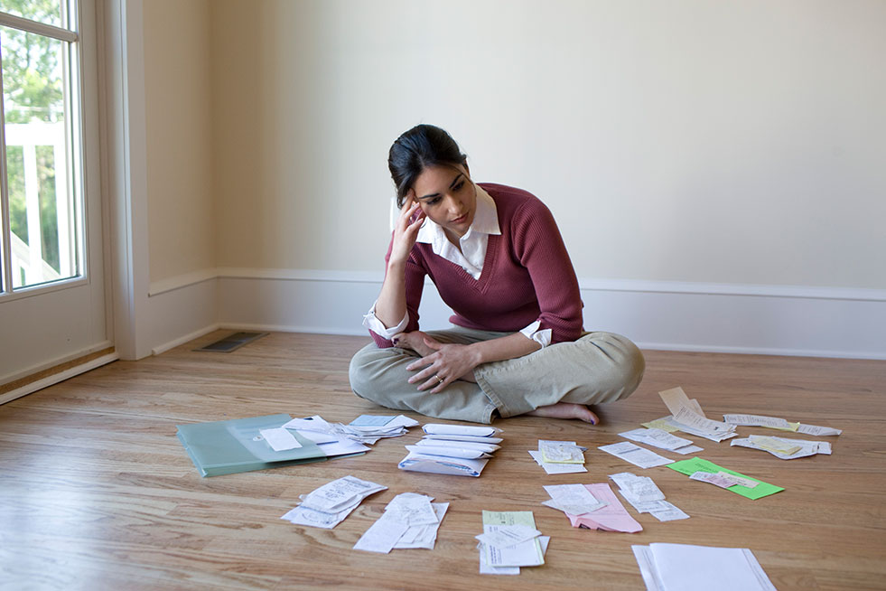 view of a lady with financial bills